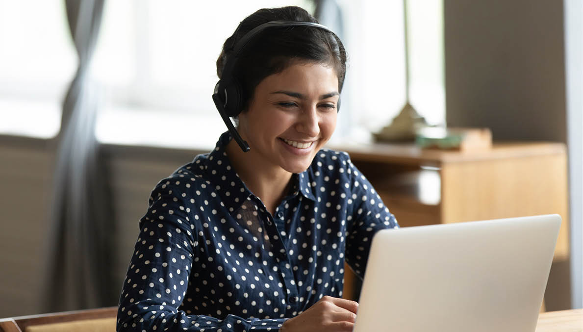 Head shot attractive happy friendly indian woman sitting at desk, holding video call with friends at home  Smiling young mixed race hotline specialist helping customers remotely at workplace 